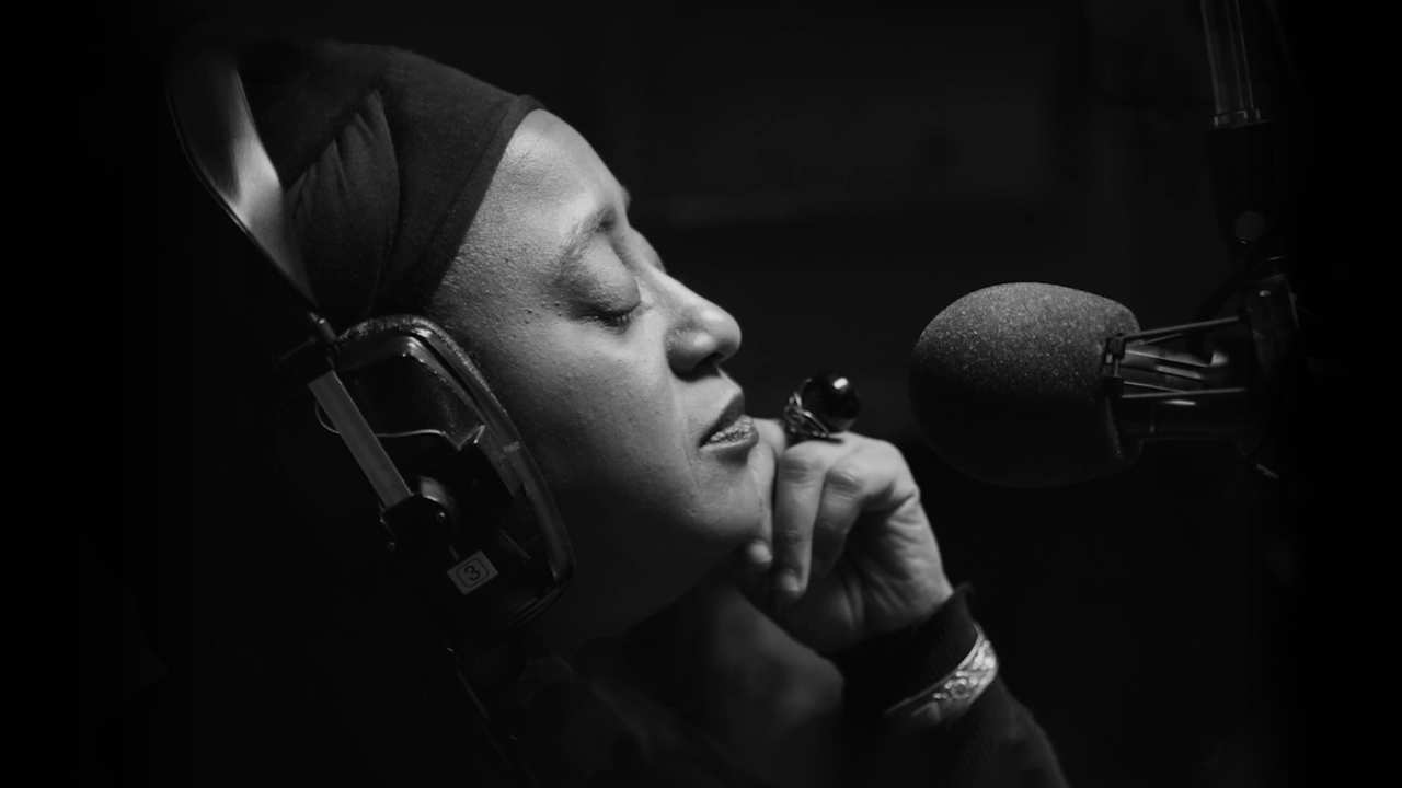 a woman in front of a microphone